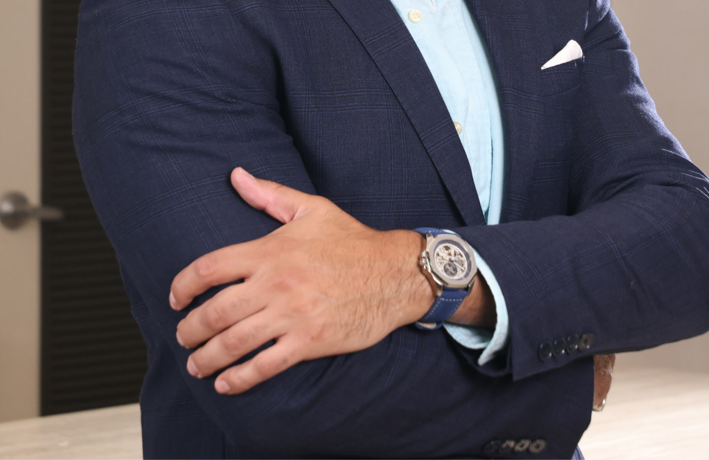 Elegant man wearing a blue suit and the Emunah EC3100 timepiece